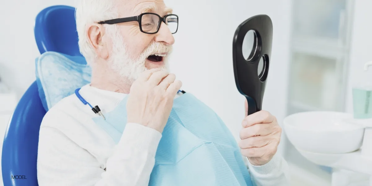 Patient looking in the mirror at his smile