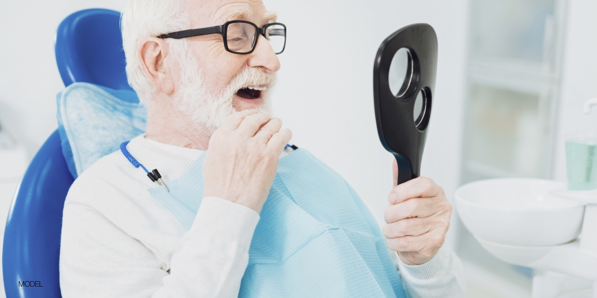 Patient looking in the mirror at his smile